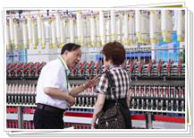 中国棉纺织协会会长朱北娜参观同和公司听取崔桂生董事长介绍紧密纺细纱机